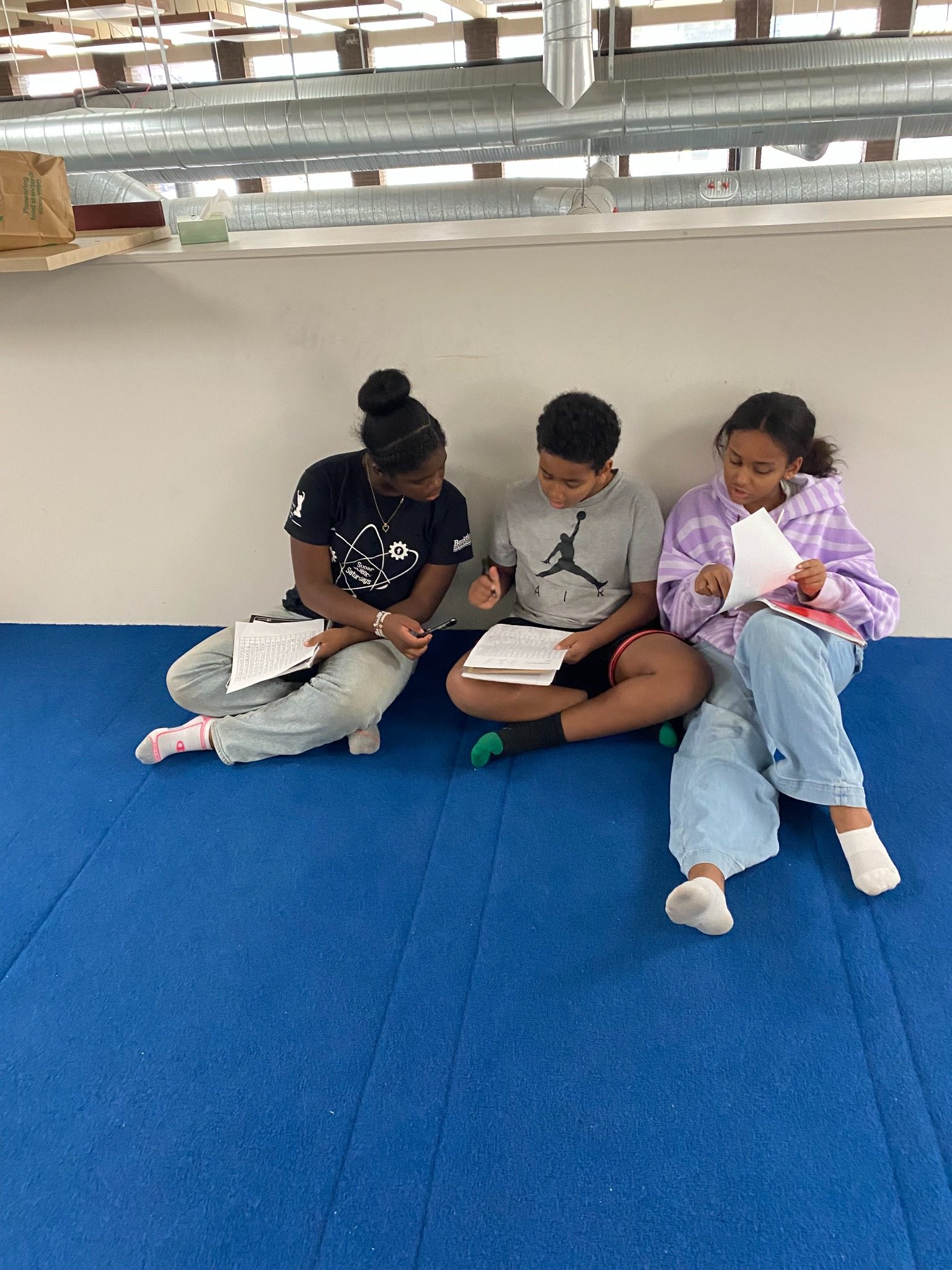Prince Academy students sitting together during program time